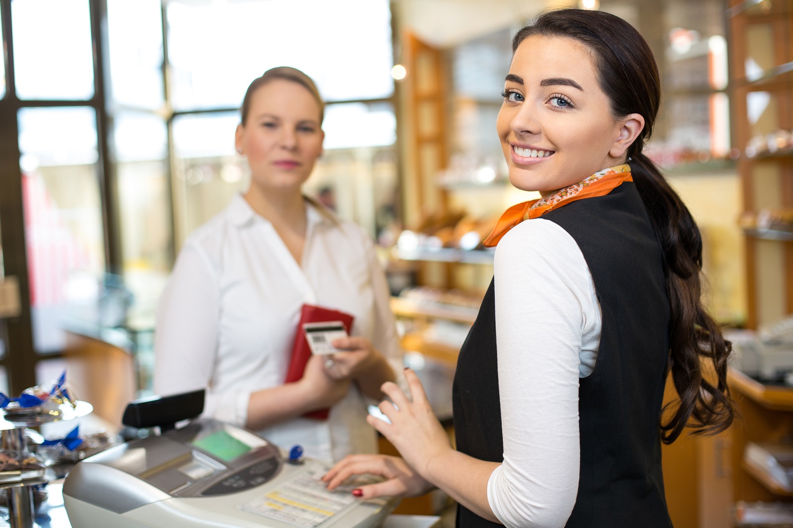 Client At Shop Paying At Cash Register